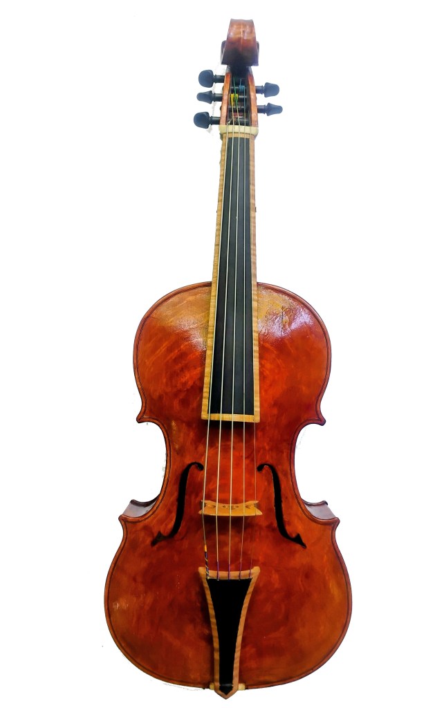 A close-up image of a wooden violin showcasing its body, strings, and fingerboard.